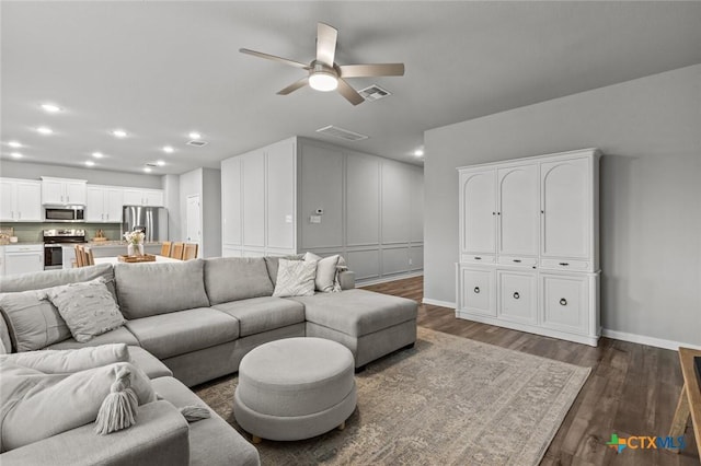 living area featuring visible vents, recessed lighting, baseboards, ceiling fan, and dark wood-style flooring