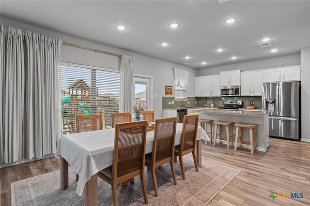 dining area featuring recessed lighting, visible vents, and light wood finished floors