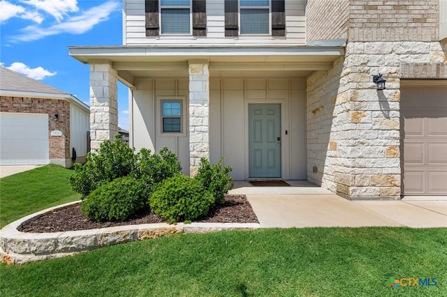 doorway to property featuring stone siding and a yard