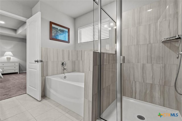 full bath featuring tile patterned flooring, a garden tub, and a stall shower