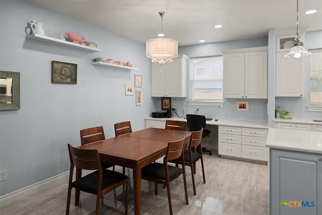 dining space featuring light hardwood / wood-style flooring and a chandelier