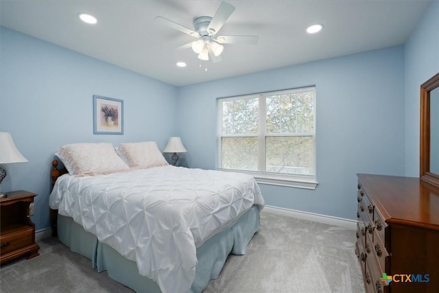 bedroom featuring light carpet and ceiling fan