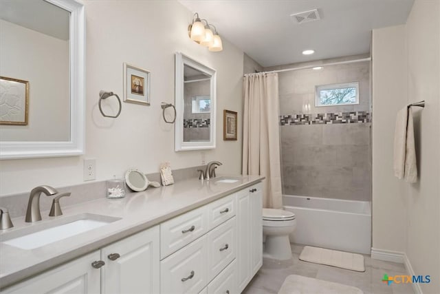 full bathroom with toilet, shower / bath combo with shower curtain, tile patterned floors, and vanity