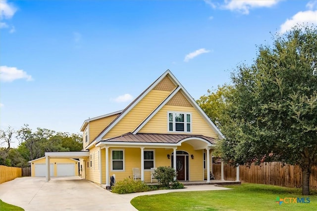 view of front facade featuring a porch, a front yard, and a garage