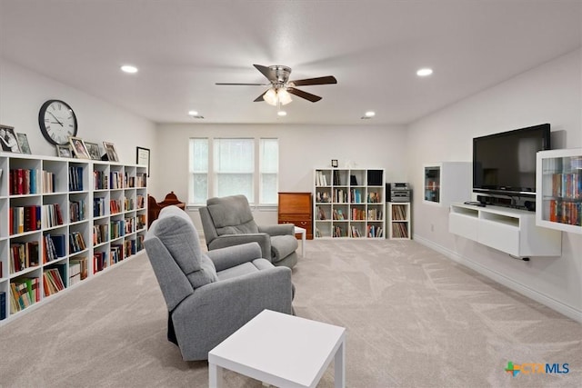 living room featuring ceiling fan and light colored carpet