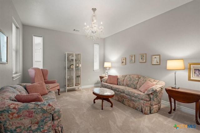 carpeted living room with a notable chandelier