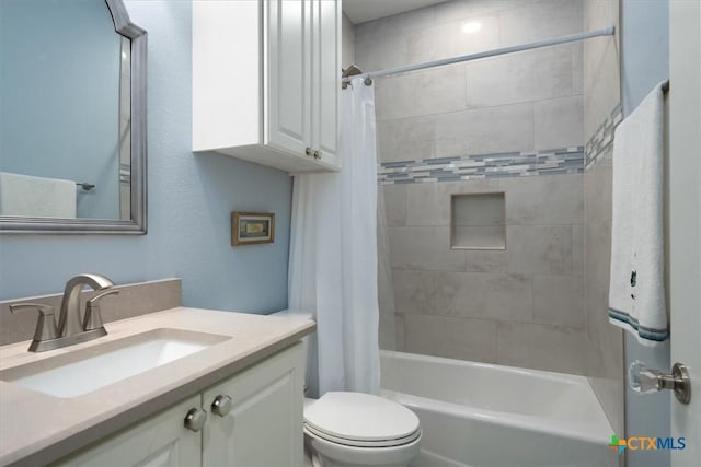 full bathroom featuring toilet, vanity, and shower / bath combination with curtain