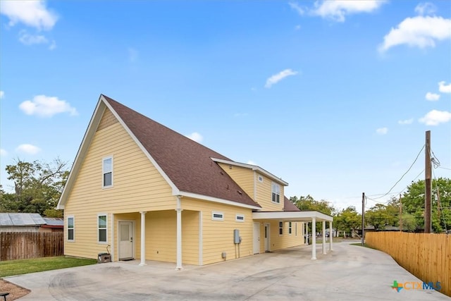 rear view of property with a carport