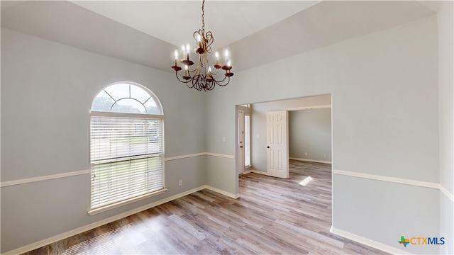 205 Crosswind Dr, Victoria, TX 77904 - spare room with a chandelier, wood finished floors, baseboards, and vaulted ceiling