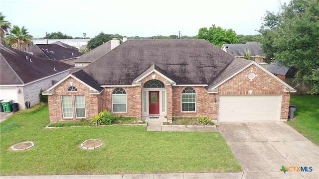 205 Crosswind Dr, Victoria, TX 77904 - view of front facade featuring brick siding, an attached garage, and a front lawn