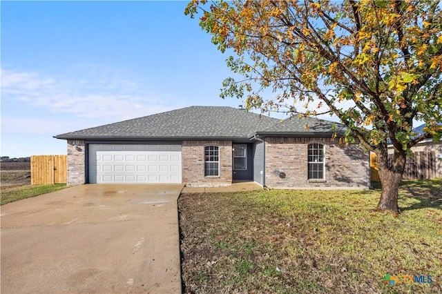 ranch-style home featuring a garage and a front lawn