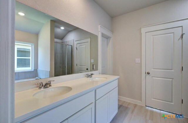 bathroom featuring vanity and an enclosed shower