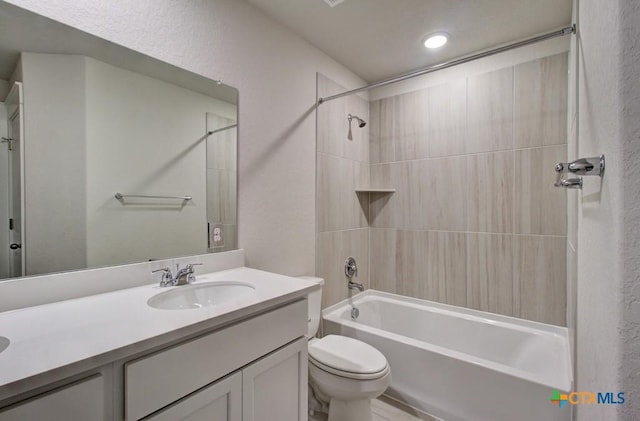 full bathroom featuring bathtub / shower combination, vanity, and toilet