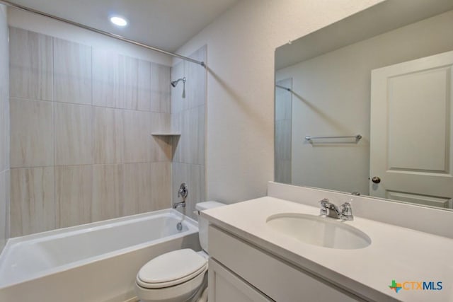 full bathroom featuring vanity, toilet, and tiled shower / bath