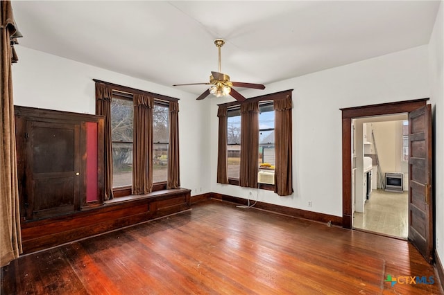 unfurnished room with dark hardwood / wood-style floors and ceiling fan