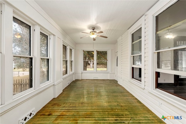 unfurnished sunroom with ceiling fan