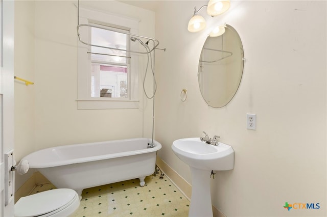 bathroom with a bathing tub and toilet