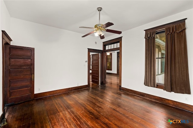 empty room featuring ceiling fan and dark hardwood / wood-style floors