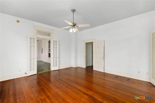 unfurnished room featuring dark wood-type flooring, ceiling fan, and french doors