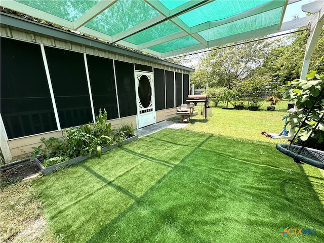 view of yard featuring a sunroom