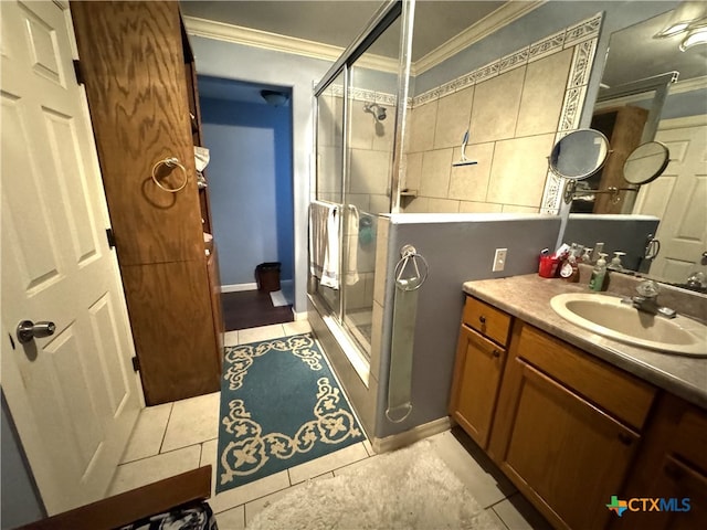 bathroom with ornamental molding, tile patterned flooring, an enclosed shower, and vanity