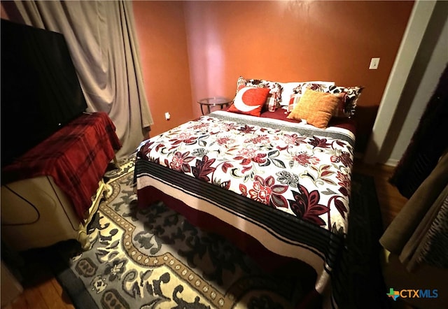 bedroom with wood-type flooring