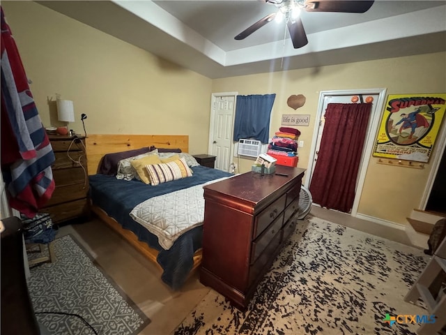 bedroom with ceiling fan and cooling unit