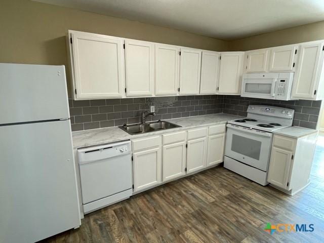 kitchen featuring sink, white appliances, decorative backsplash, and white cabinets