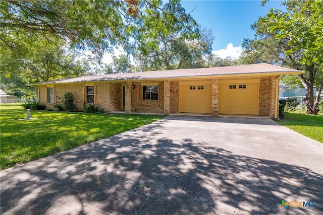 single story home with a garage, a front lawn, and a carport