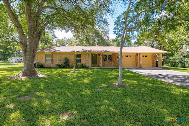 single story home featuring a garage and a front lawn