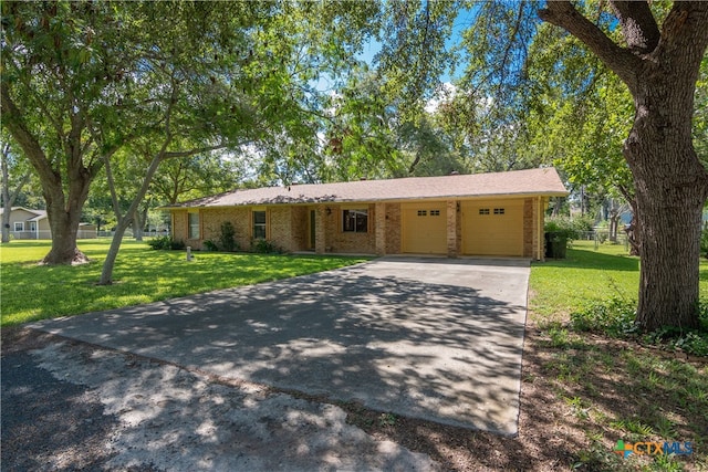 ranch-style house featuring a garage and a front lawn