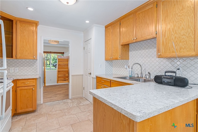 kitchen with white electric range oven, kitchen peninsula, sink, tasteful backsplash, and ornamental molding