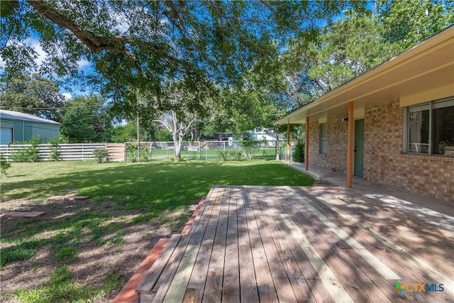 wooden terrace with a yard