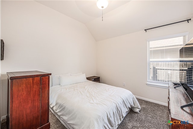 carpeted bedroom featuring lofted ceiling and ceiling fan