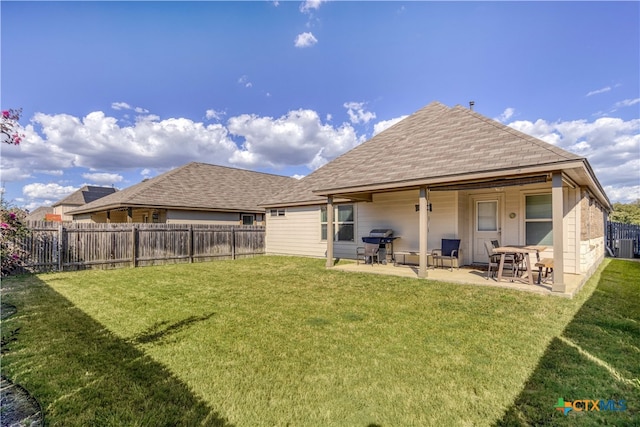 back of property featuring a lawn and a patio area