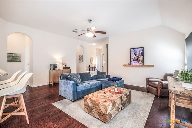 living room with dark wood-type flooring, ceiling fan, and lofted ceiling