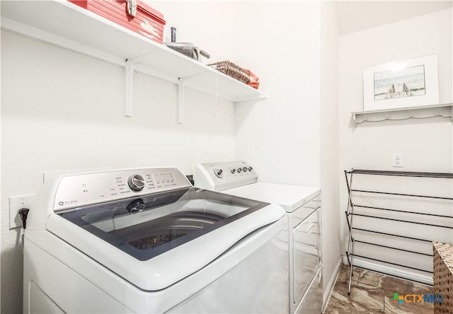 clothes washing area with washing machine and dryer