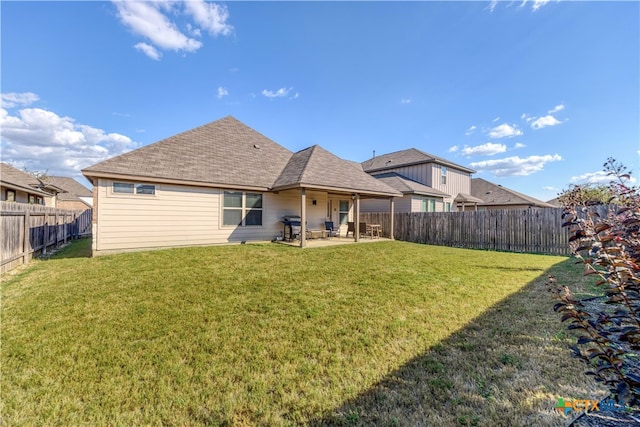 back of house with a lawn and a patio area