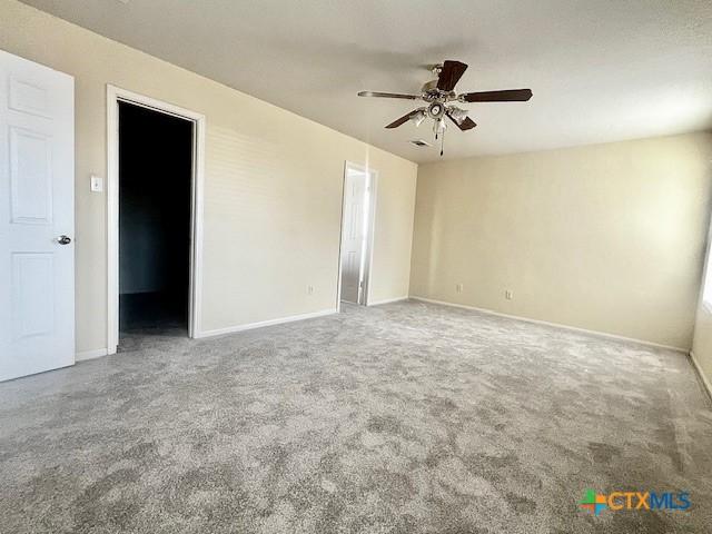 unfurnished room with carpet flooring and ceiling fan