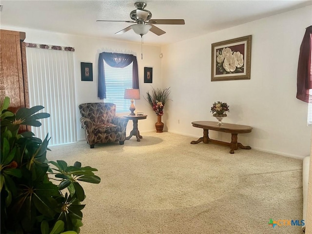 living area with carpet floors and ceiling fan