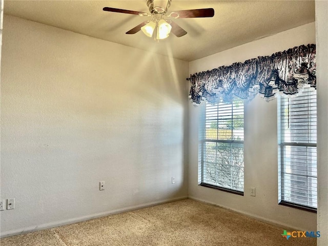 carpeted empty room featuring ceiling fan