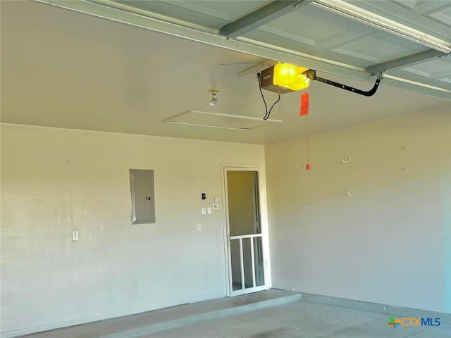 garage with electric panel and a garage door opener