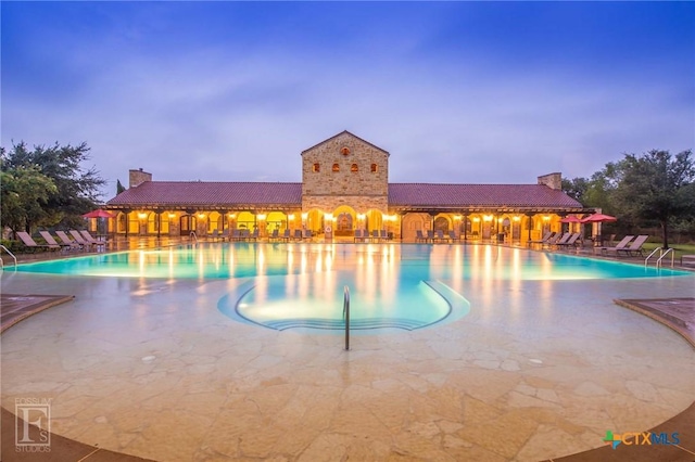 community pool with a patio area