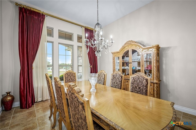 dining area with a chandelier and baseboards