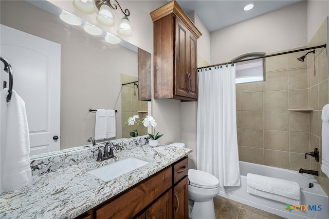 bathroom featuring shower / bath combination with curtain, tile patterned flooring, vanity, and toilet