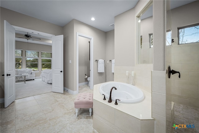 ensuite bathroom featuring toilet, connected bathroom, a jetted tub, baseboards, and walk in shower