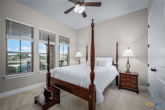 bedroom with carpet flooring, ceiling fan, baseboards, and multiple windows