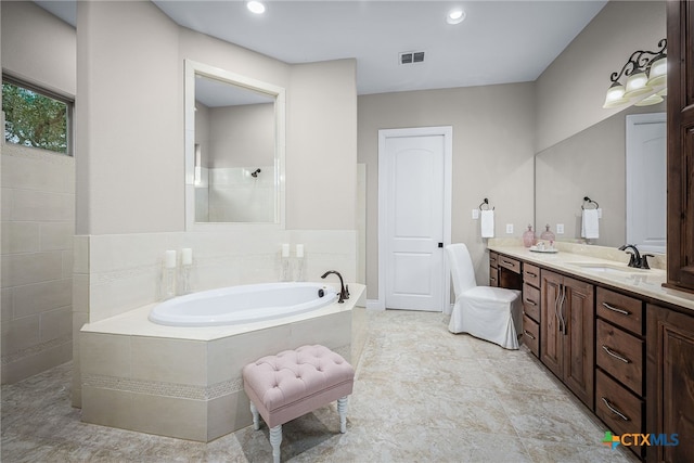 full bathroom featuring recessed lighting, visible vents, vanity, a bath, and walk in shower