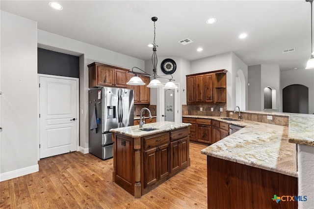 2299 Sun Chase Blvd, New Braunfels, TX 78130 - kitchen featuring stainless steel appliances, open shelves, light wood-type flooring, light stone counters, and recessed lighting