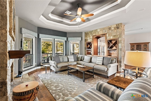 2299 Sun Chase Blvd, New Braunfels, TX 78130 - living area with a raised ceiling, wood finished floors, and ceiling fan